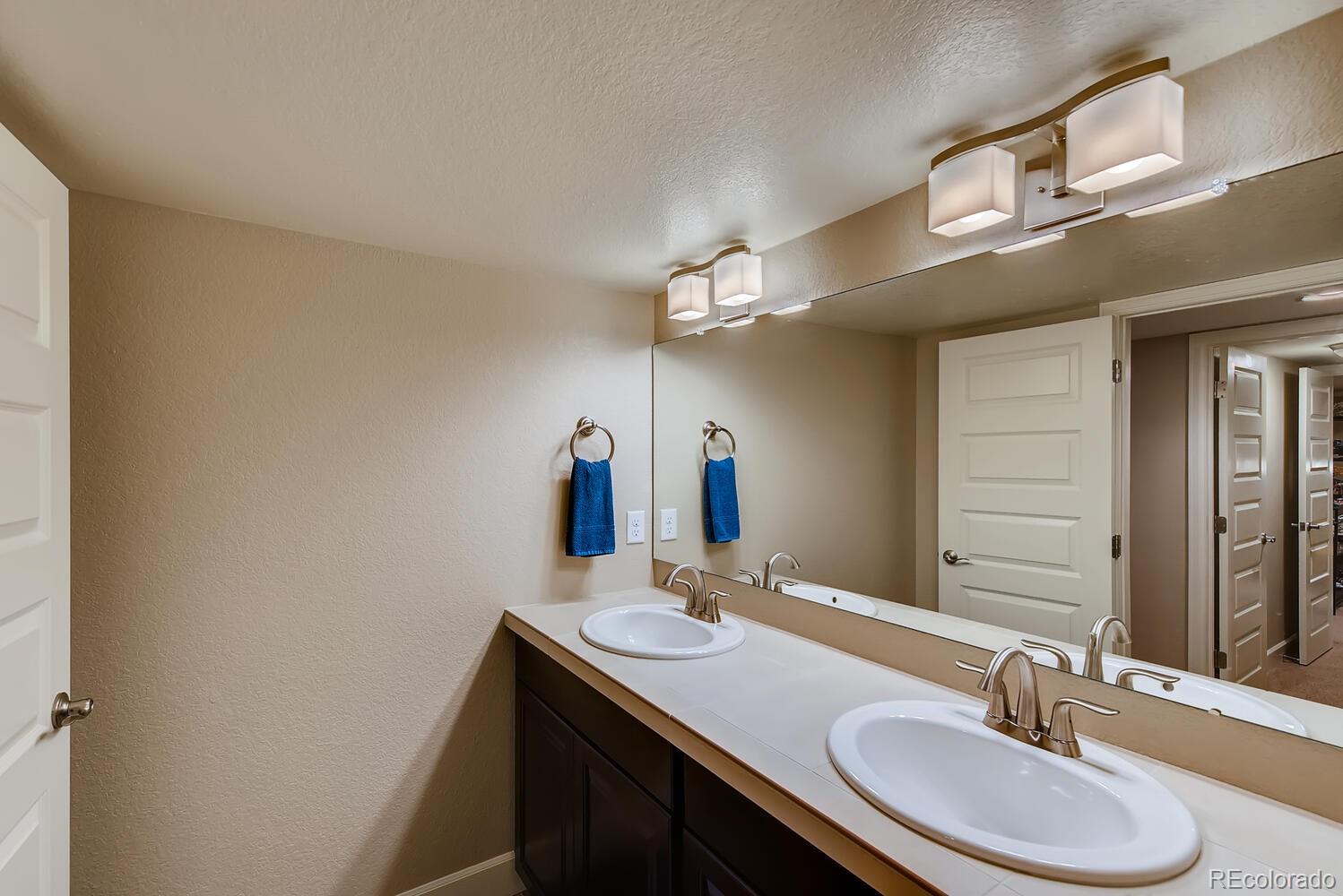 8413 Raspberry Drive Frederick, CO 80504 - Photo 22 of 27 a bathroom with a sink and a mirror