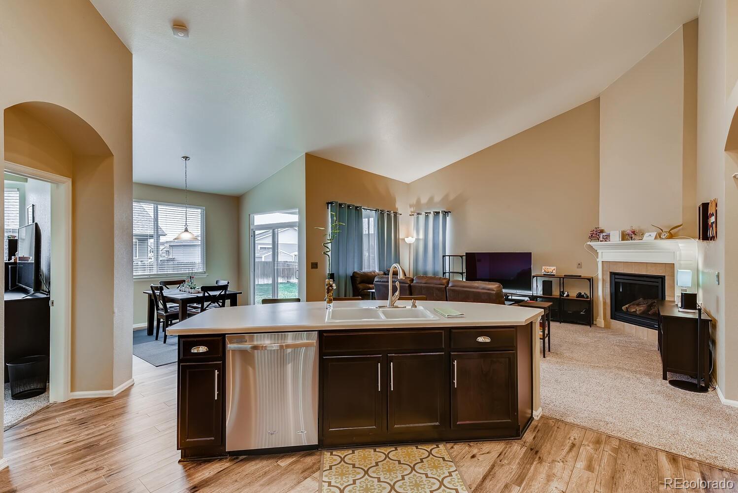8413 Raspberry Drive Frederick, CO 80504 - Photo 8 of 27 a kitchen with stainless steel appliances granite countertop a stove a sink and a refrigerator