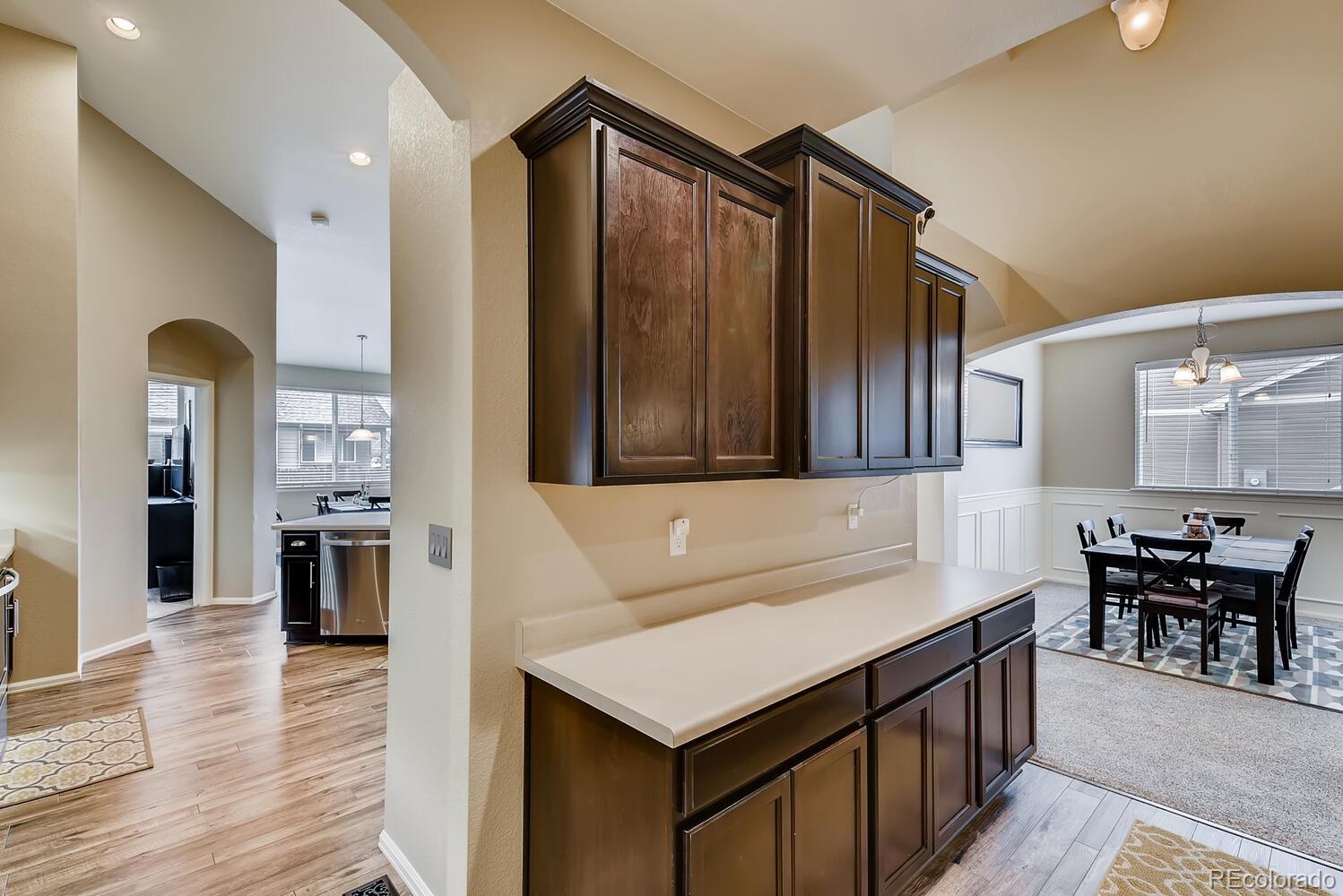 8413 Raspberry Drive Frederick, CO 80504 - Photo 10 of 27 a kitchen that has a kitchen island wooden cabinets and stainless steel appliances