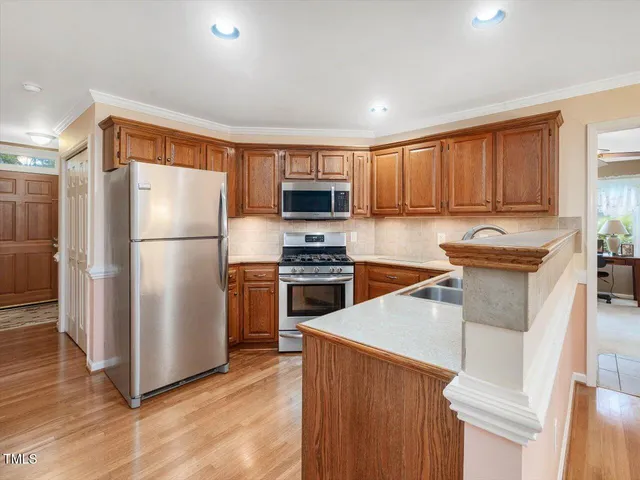 a kitchen with stainless steel appliances a sink stove and microwave