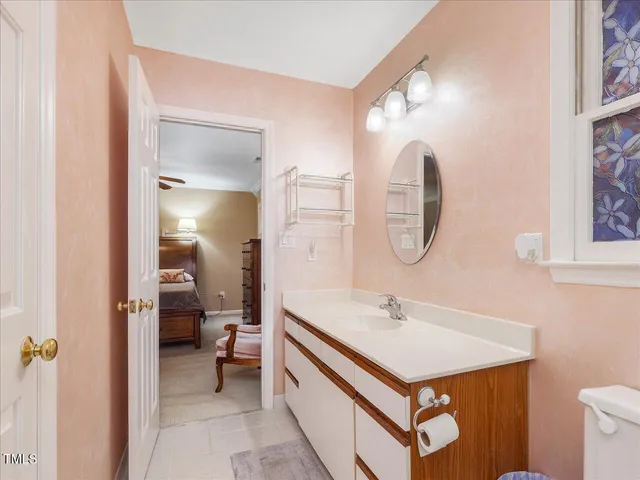 an empty room with chandelier fan and closet area