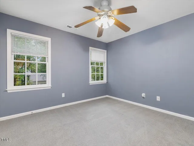 a view of a house with a yard and tree s