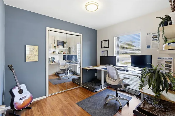 a view of a workspace with furniture and a window
