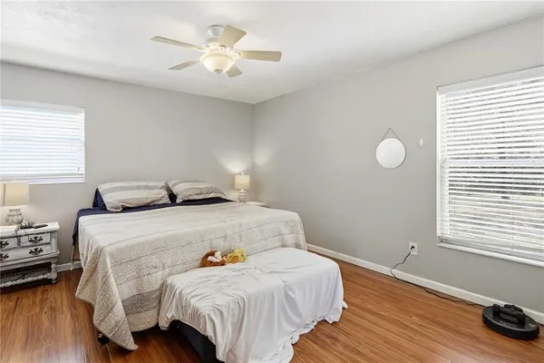 a bedroom with a bed and wooden floor