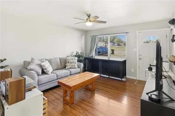 a living room with furniture gym equipment and a view of kitchen