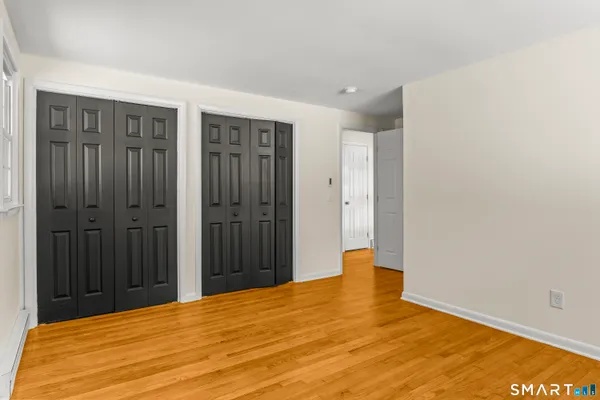 a view of an empty room with wooden floor