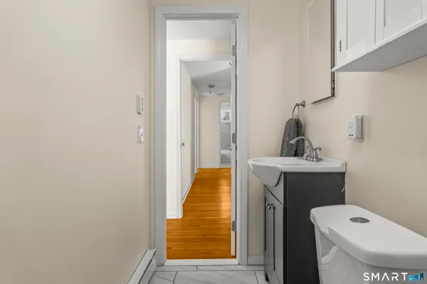 a view of a room with wooden floor and a window