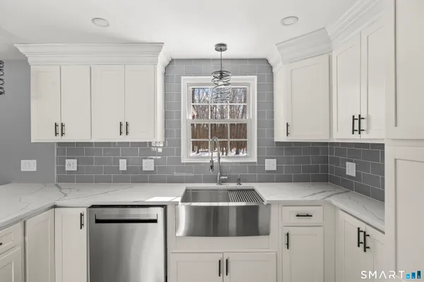 a kitchen with stainless steel appliances a refrigerator a stove a microwave and cabinets