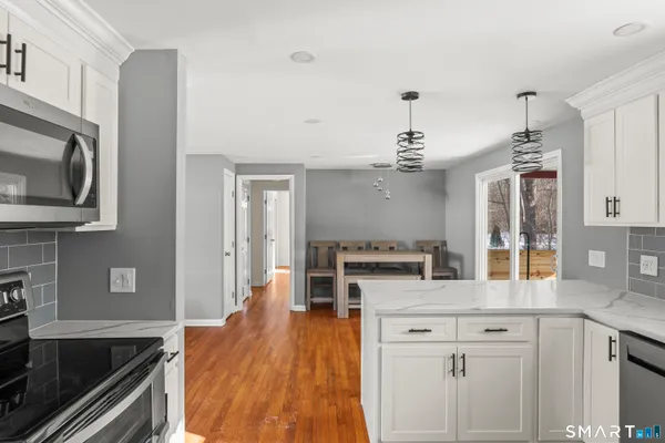 a kitchen with kitchen island a sink stainless steel appliances and cabinets