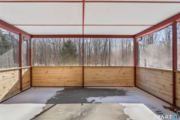 a view of a porch with a table and chairs