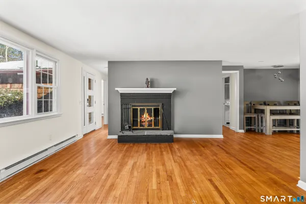 a view of kitchen with furniture and wooden floor