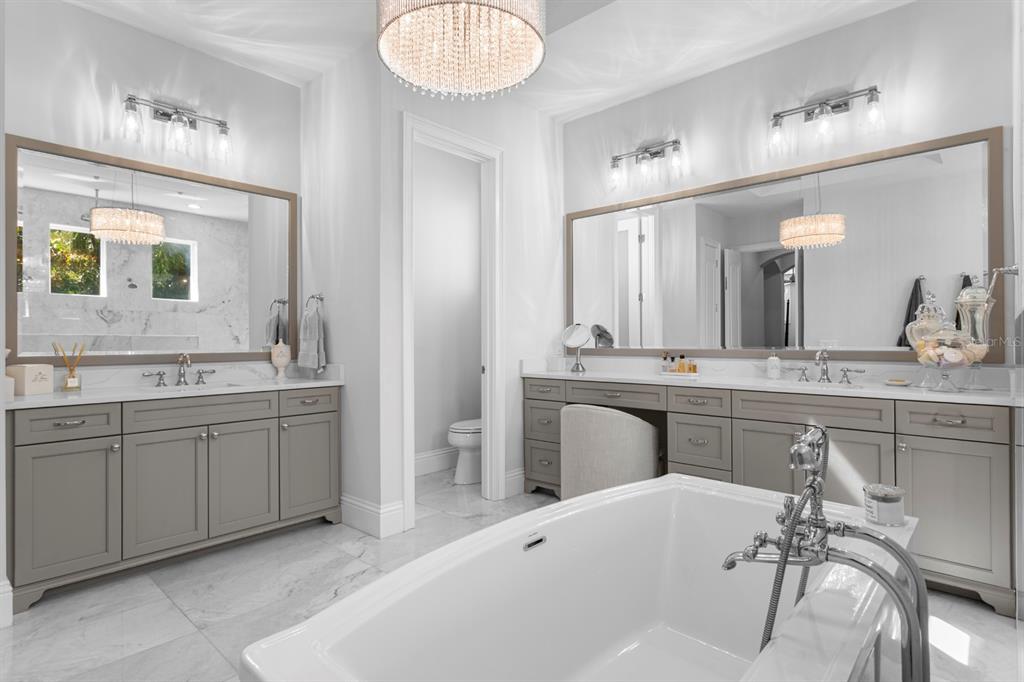 2604 South Bryant Circle Tampa, FL 33629 - Photo 29 of 49 a spacious bathroom with a granite countertop sink a mirror a vanity and bathtub