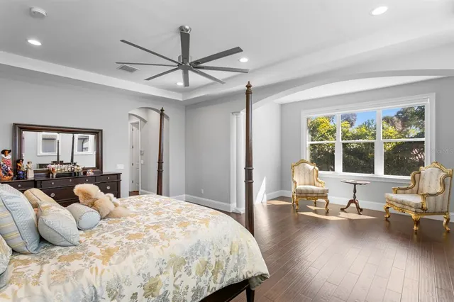 a bedroom with a large bed and a window