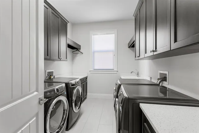 a bathroom with a granite countertop bathtub sink vanity mirror and toilet