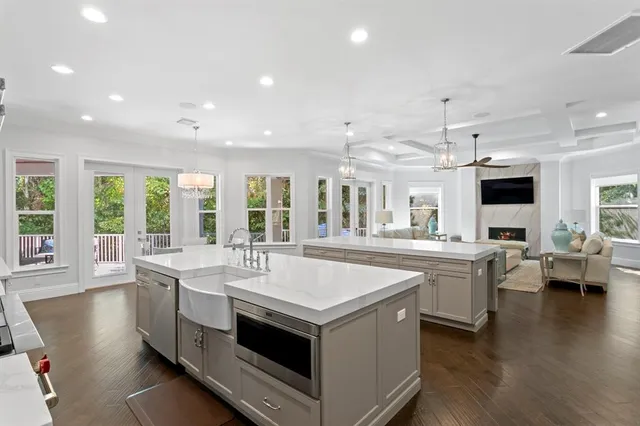 a large white kitchen with a large window