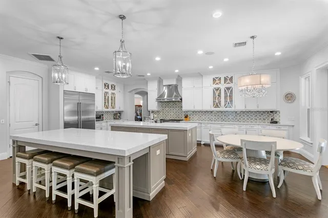 a large kitchen with a table and chairs