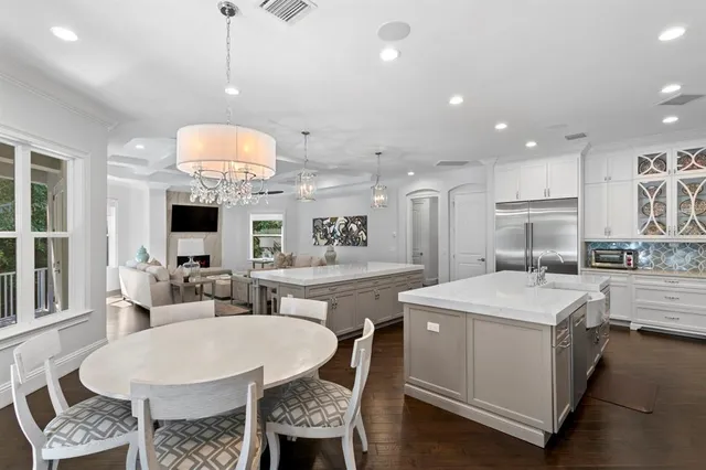 a large kitchen with a table and chairs