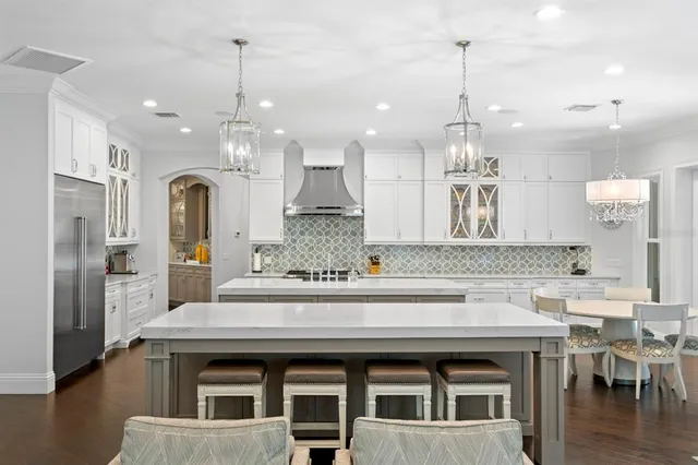 a large kitchen with a table and chairs