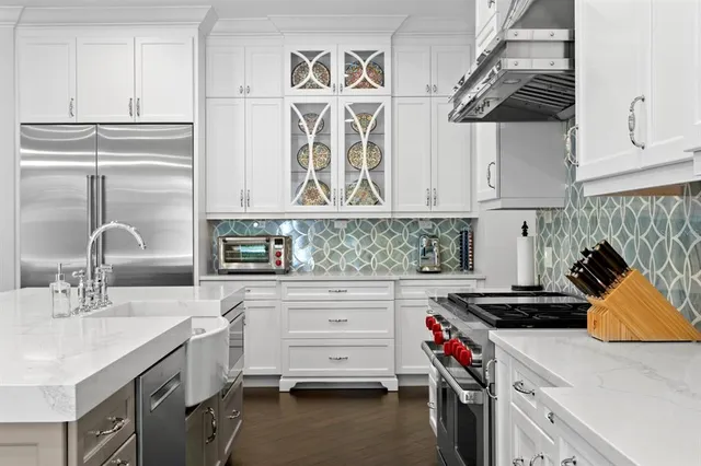 a kitchen with a sink stove and cabinets