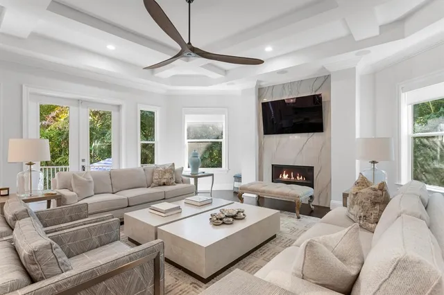 a living room with furniture a fireplace and a flat screen tv