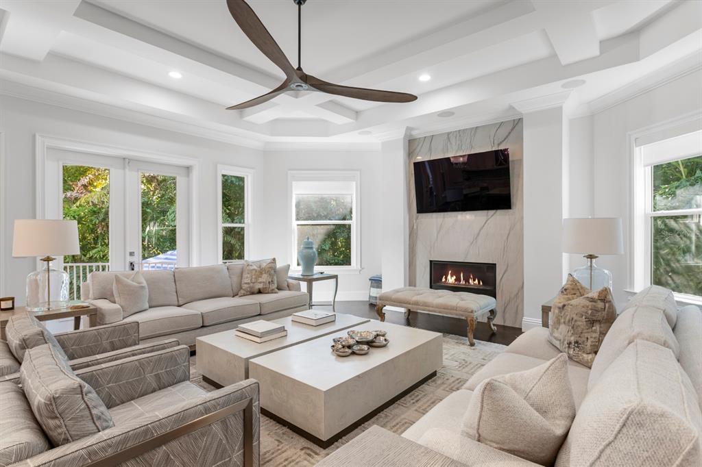 2604 South Bryant Circle Tampa, FL 33629 - Photo 10 of 49 a living room with furniture a fireplace and a flat screen tv