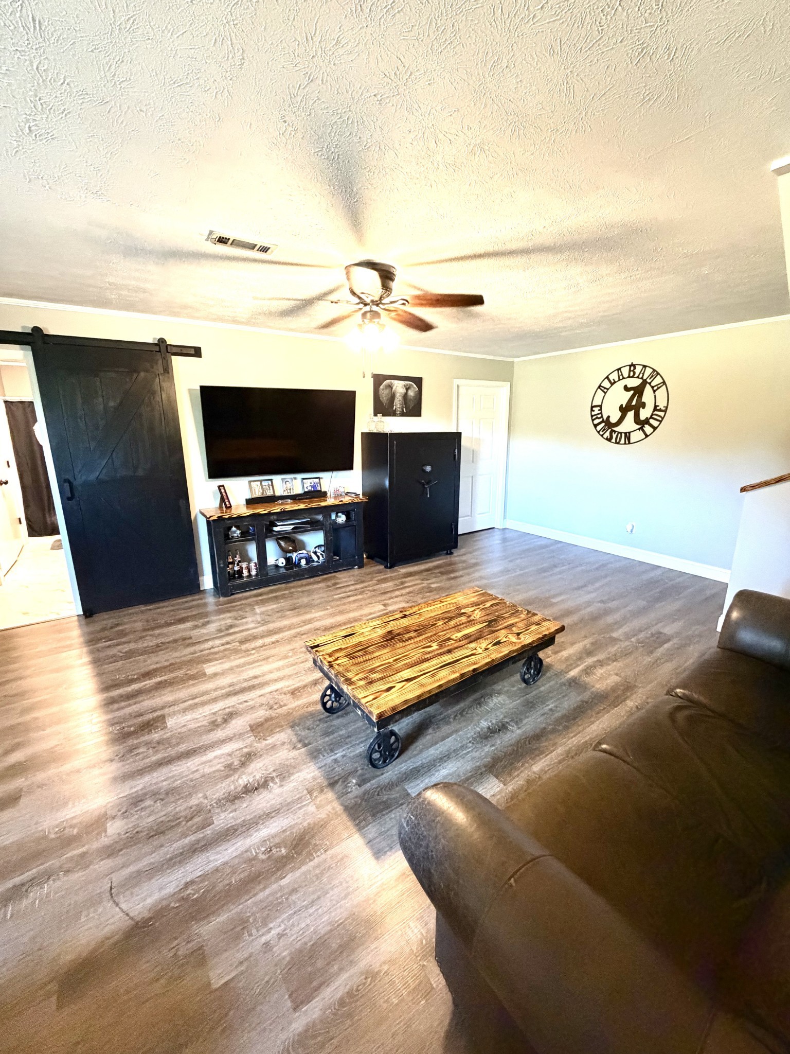 356 Lee Road Cottontown, TN 37048 - Photo 32 of 52 a living room with hard wood floor and a flat screen tv