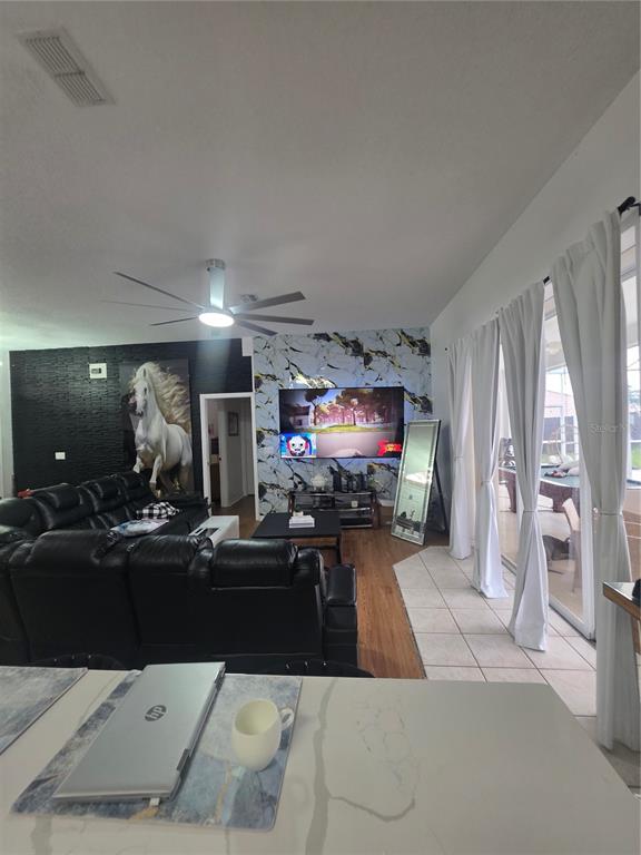 17820 Monteverde Drive Spring Hill, FL 34610 - Photo 22 of 42 a living room with furniture and a flat screen tv