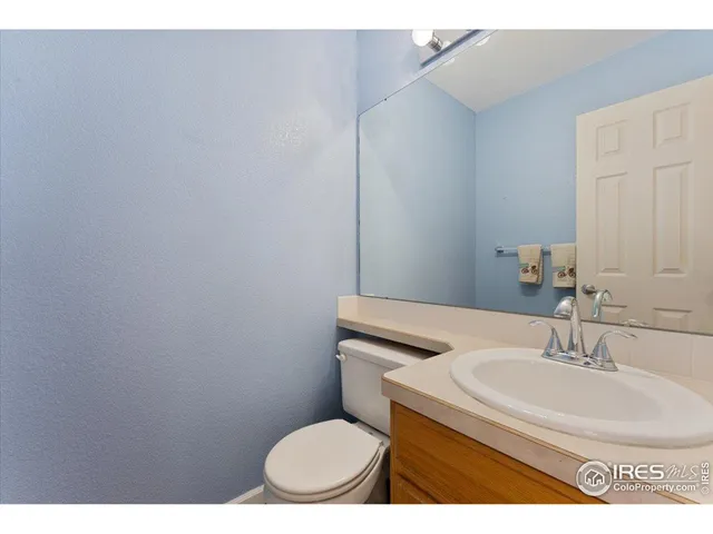 a bathroom with a sink toilet and a mirror