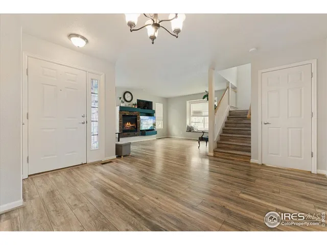 a view of a livingroom with wooden floor and staircase