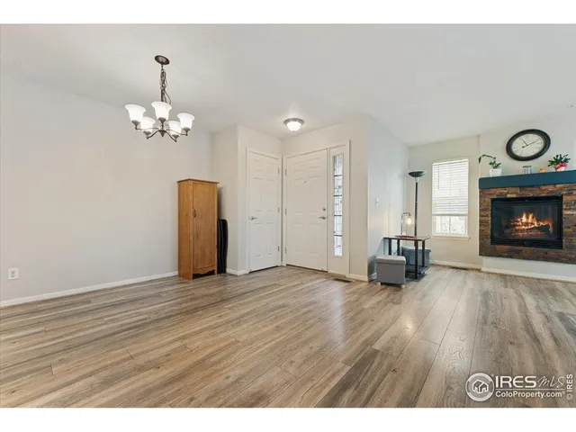 a view of an empty room with fire place and a fireplace