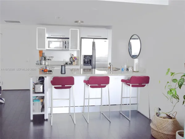 a kitchen with a table and chairs in it
