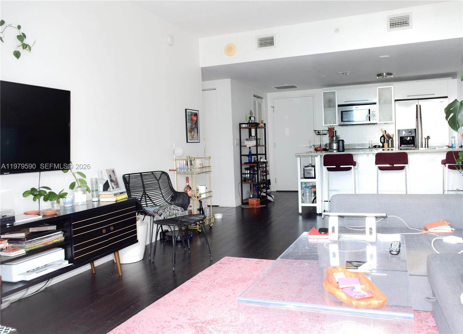 185 Southwest 7th Street, Unit 2814 Miami, FL 33130 - Photo 3 of 8 a living room with furniture and a flat screen tv