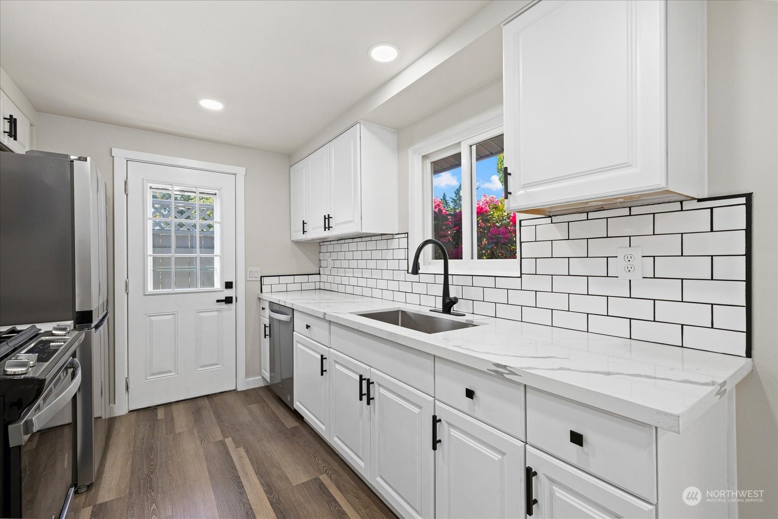 16820 120th Avenue Southeast Renton, WA 98058 - Photo 12 of 31 a kitchen with a sink cabinets and appliances