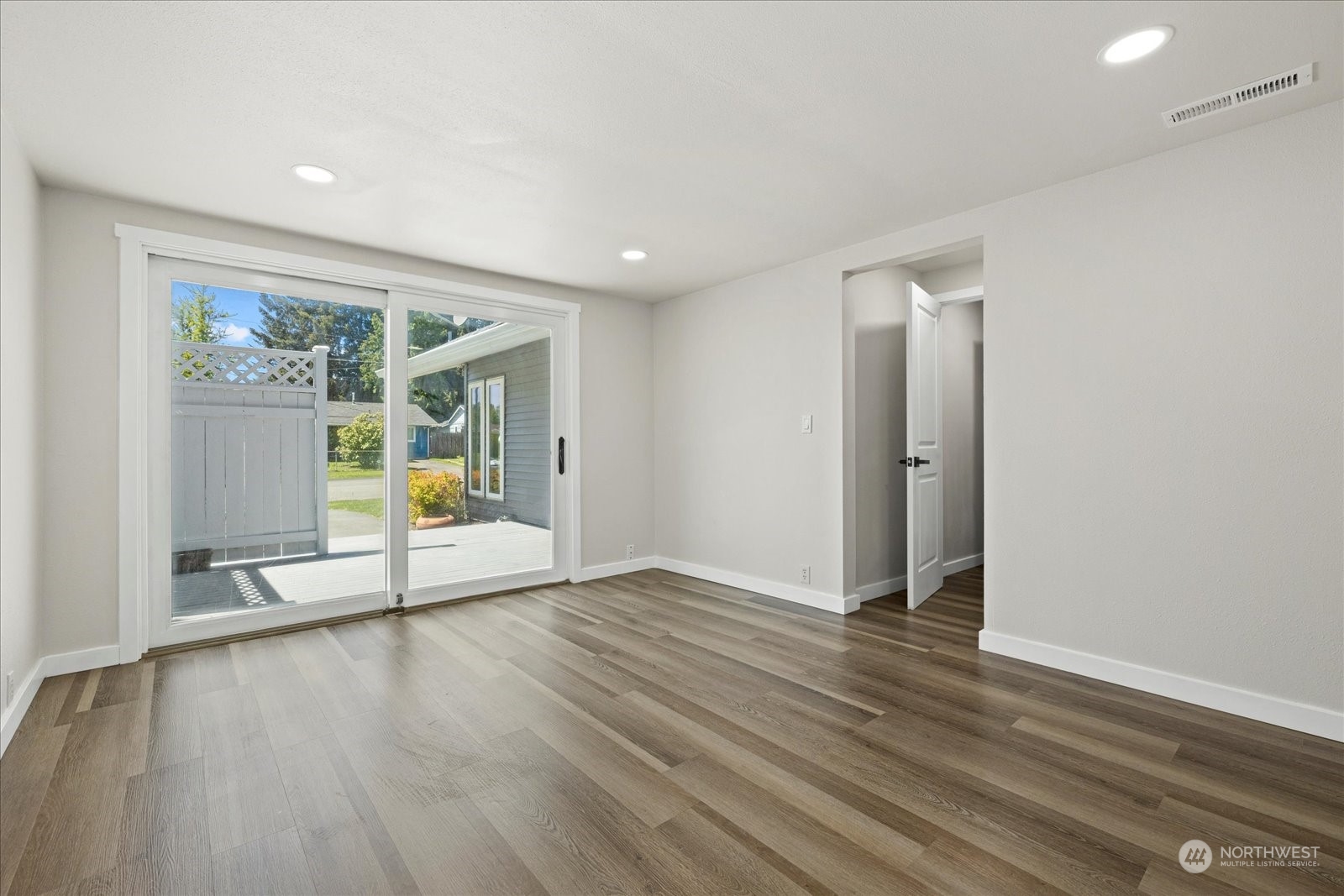 16820 120th Avenue Southeast Renton, WA 98058 - Photo 21 of 31 an empty room with wooden floor and glass door