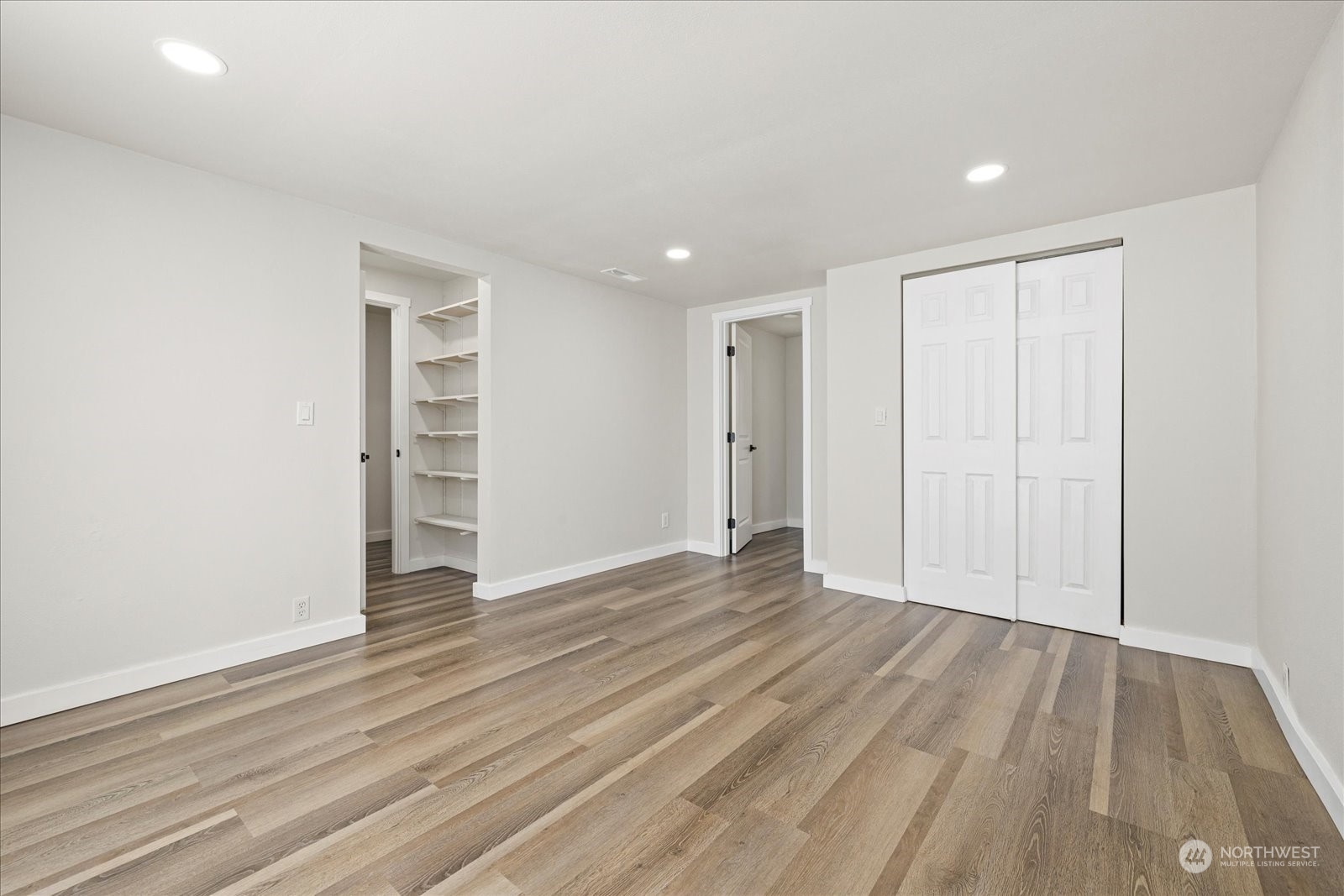 16820 120th Avenue Southeast Renton, WA 98058 - Photo 22 of 31 a view of an empty room with wooden floor and closet