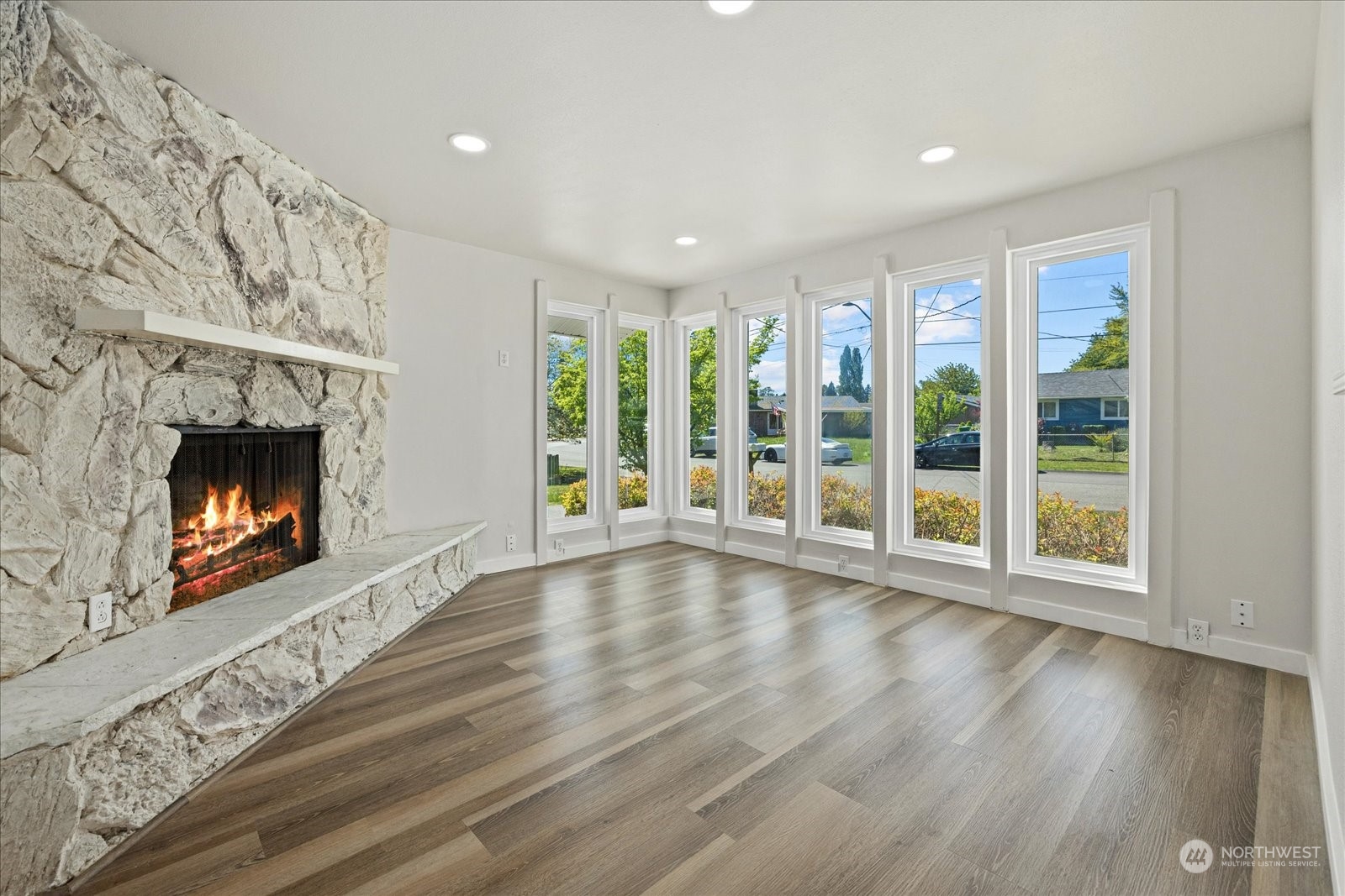 16820 120th Avenue Southeast Renton, WA 98058 - Photo 25 of 31 a view of an empty room with wooden floor fireplace and a window