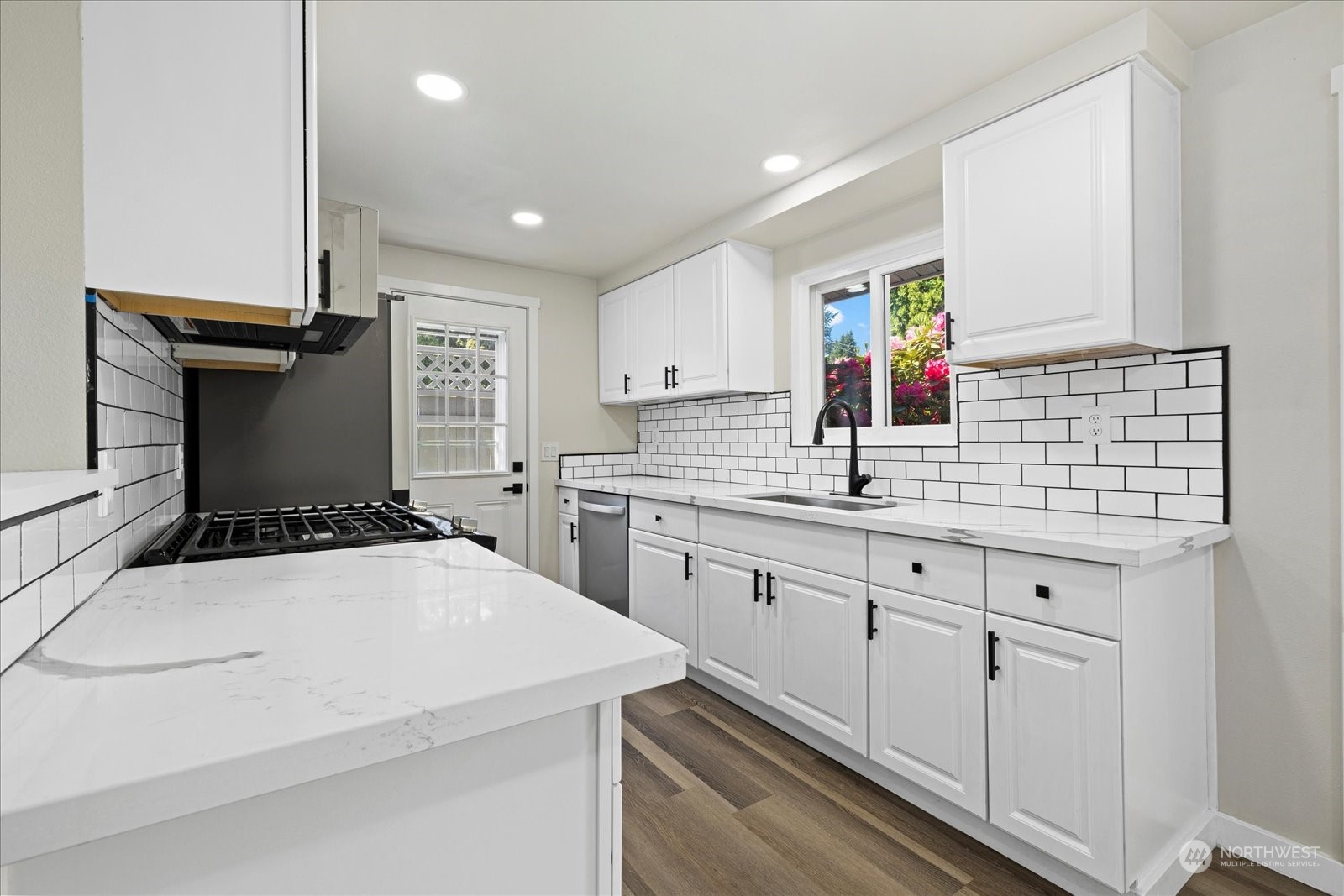 16820 120th Avenue Southeast Renton, WA 98058 - Photo 10 of 31 a kitchen that has a sink and a stove in it