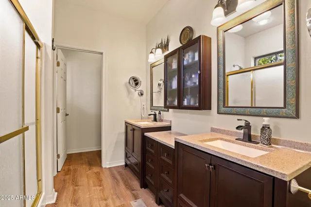 a bathroom with a double vanity sink and mirror