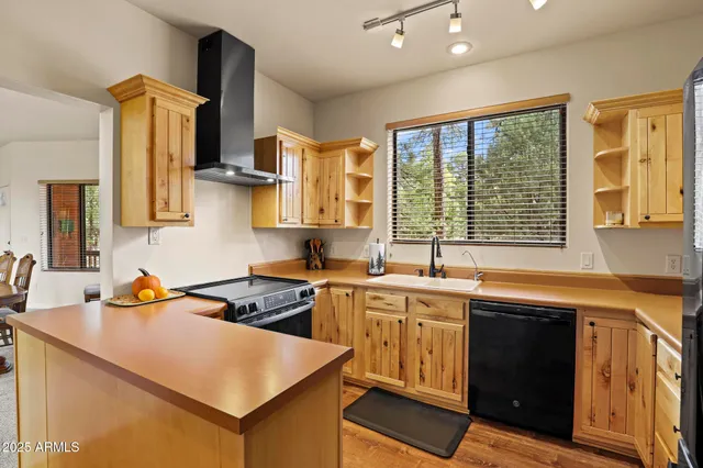 a kitchen that has a sink and a stove in it