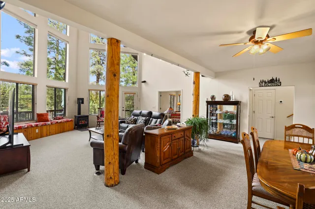 a living room with furniture and large windows