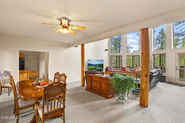 a dining room with furniture garden view and a chandelier