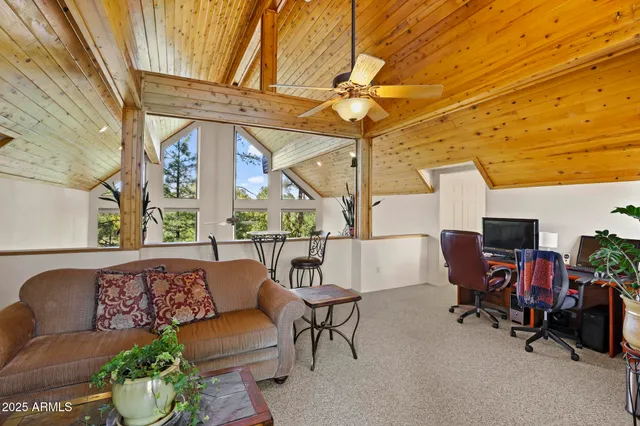 a living room with furniture a fireplace and a window