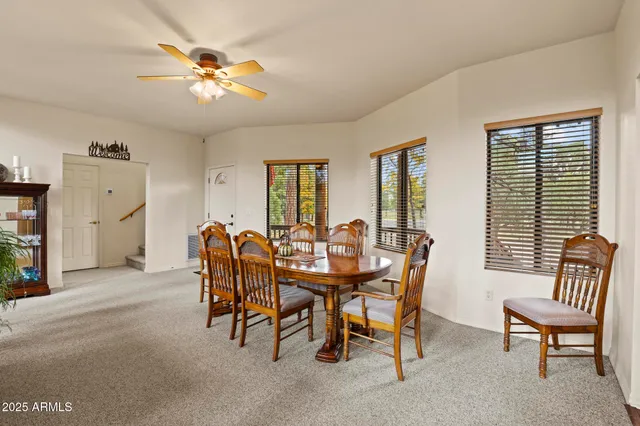 a view of a dining room with furniture and chandelier