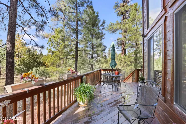 a balcony with wooden floor and outdoor seating
