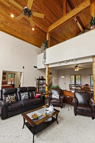 a living room with furniture a table and chairs
