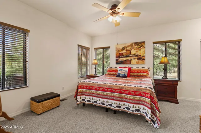 a bedroom with a bed gym equipment and window