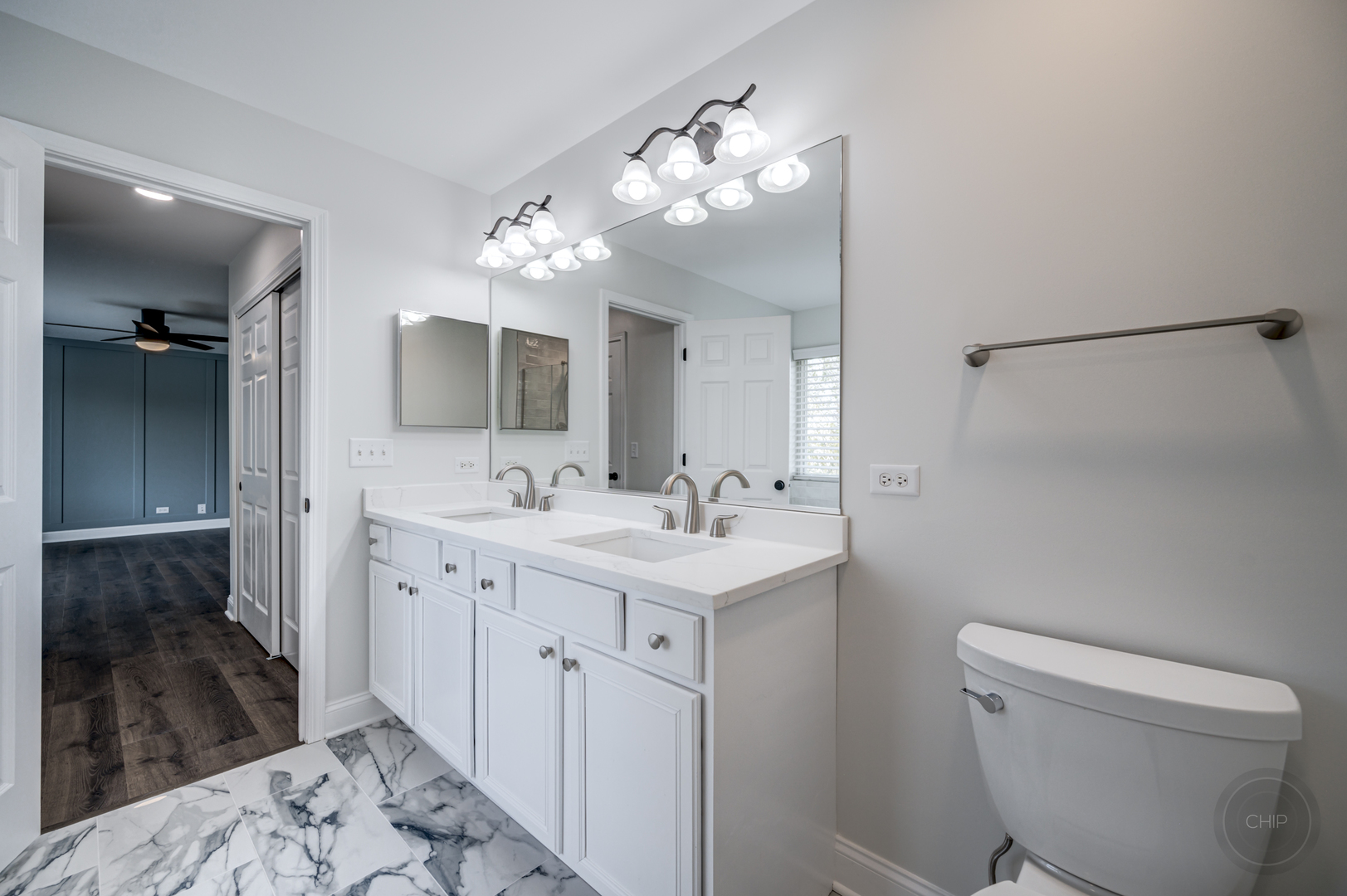 12948 Parterre Place Plainfield, IL 60585 - Photo 28 of 35 a spacious bathroom with a toilet sink and mirror
