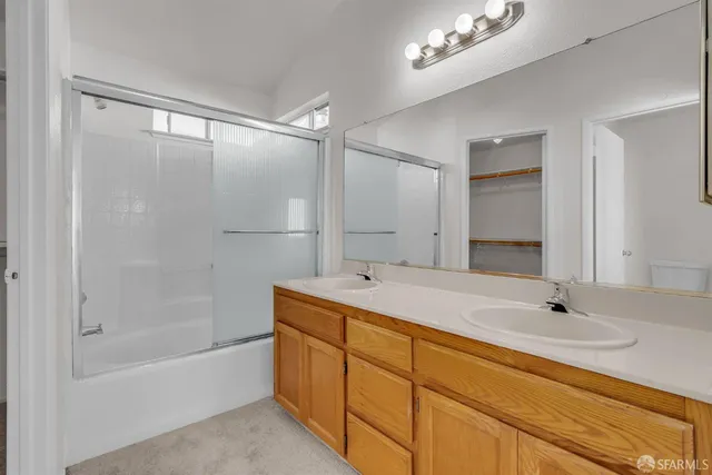 a bathroom with a tub a sink and a mirror