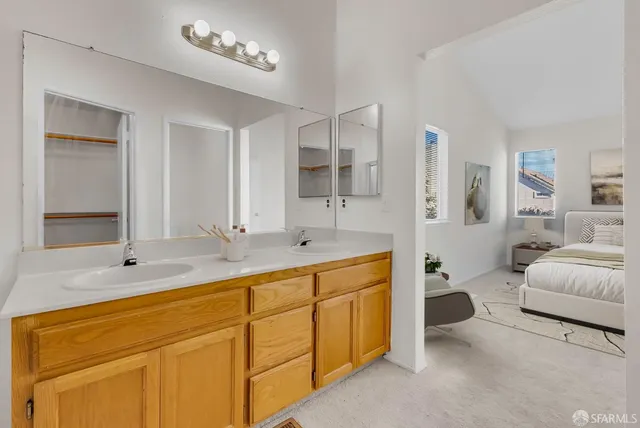 a spacious bathroom with a double vanity sink mirror and bathtub