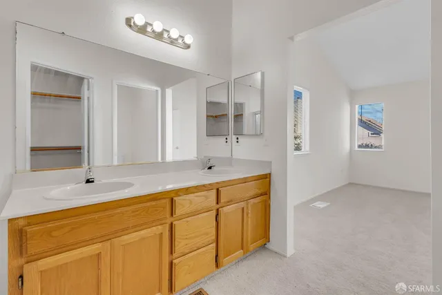a bath room with a sink and a large mirror